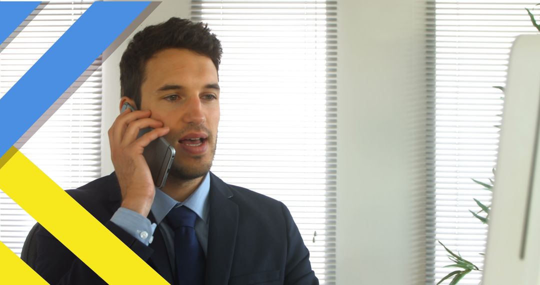 Businessman Engaging in Telephone Communication in Modern Office