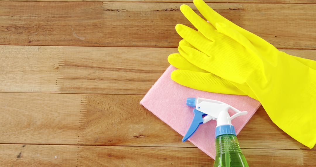 Cleaning Supplies on Wooden Floor with Rubber Gloves and Spray Bottle - Free Images, Stock Photos and Pictures on Pikwizard.com