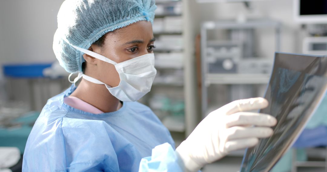 Focused Female Surgeon Examining X-ray in Operating Room - Free Images, Stock Photos and Pictures on Pikwizard.com