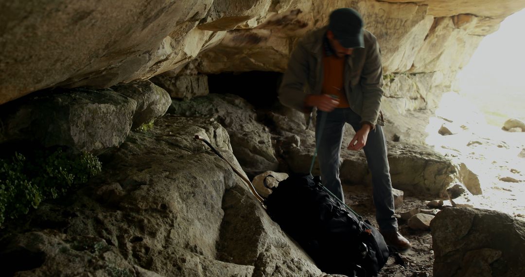 Explorer Preparing Backpack in Rocky Cave Adventure