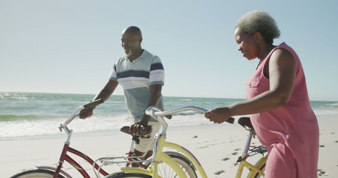 Senior African American Couple Holding Bicycles on Beach - Free Images, Stock Photos and Pictures on Pikwizard.com