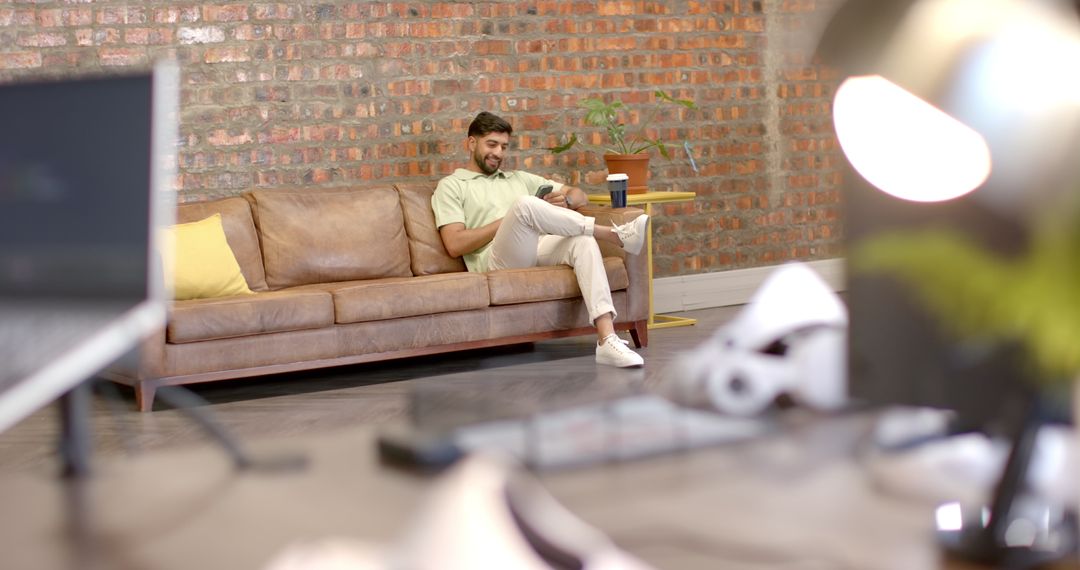Businessman Relaxing with Smartphone in Modern Office Space