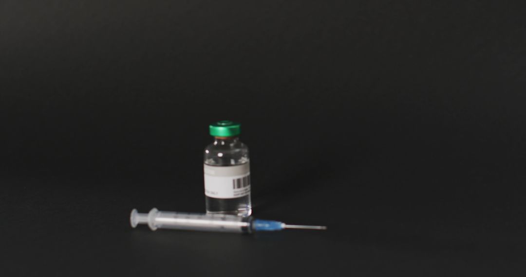 Image of close up of vaccine vial on black background - Free Images, Stock Photos and Pictures on Pikwizard.com