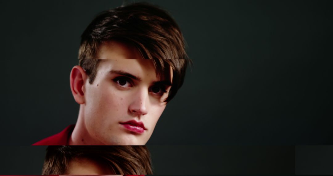 Serious Young Man with Brown Hair Looking at Camera against Dark Background - Free Images, Stock Photos and Pictures on Pikwizard.com