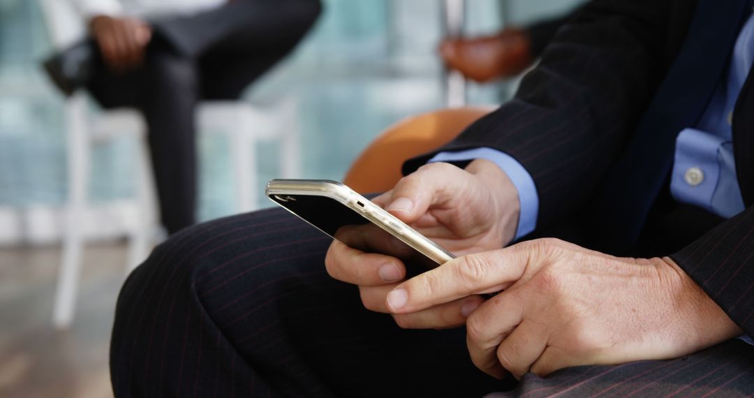 Businessperson Texting on Smartphone in Office Waiting Room - Free Images, Stock Photos and Pictures on Pikwizard.com