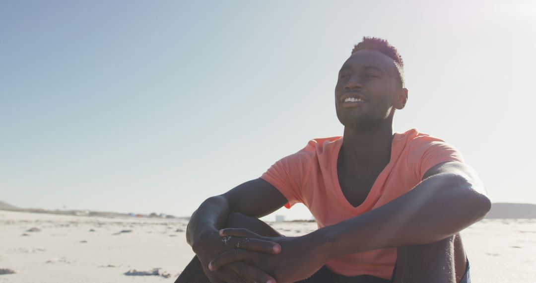 Smiling Man Sitting on Sunny Beach, Relaxing Vacation Vibes - Free Images, Stock Photos and Pictures on Pikwizard.com