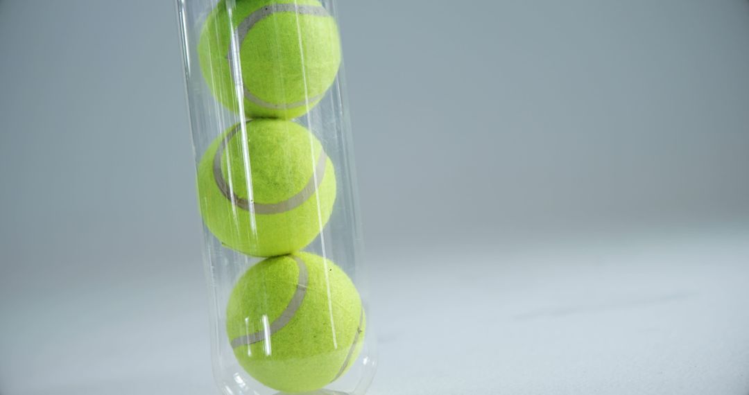 Stack of Tennis Balls in Transparent Tube on White Background - Free Images, Stock Photos and Pictures on Pikwizard.com