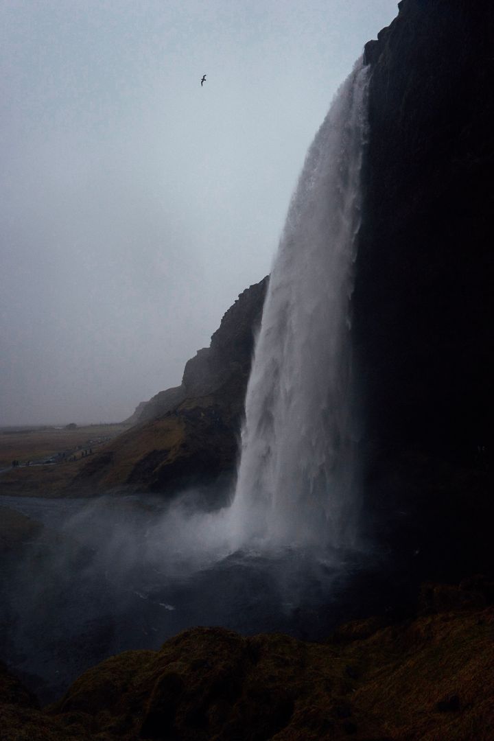 Majestic Waterfall Cascading Down Cliffs at Dusk - Free Images, Stock Photos and Pictures on Pikwizard.com