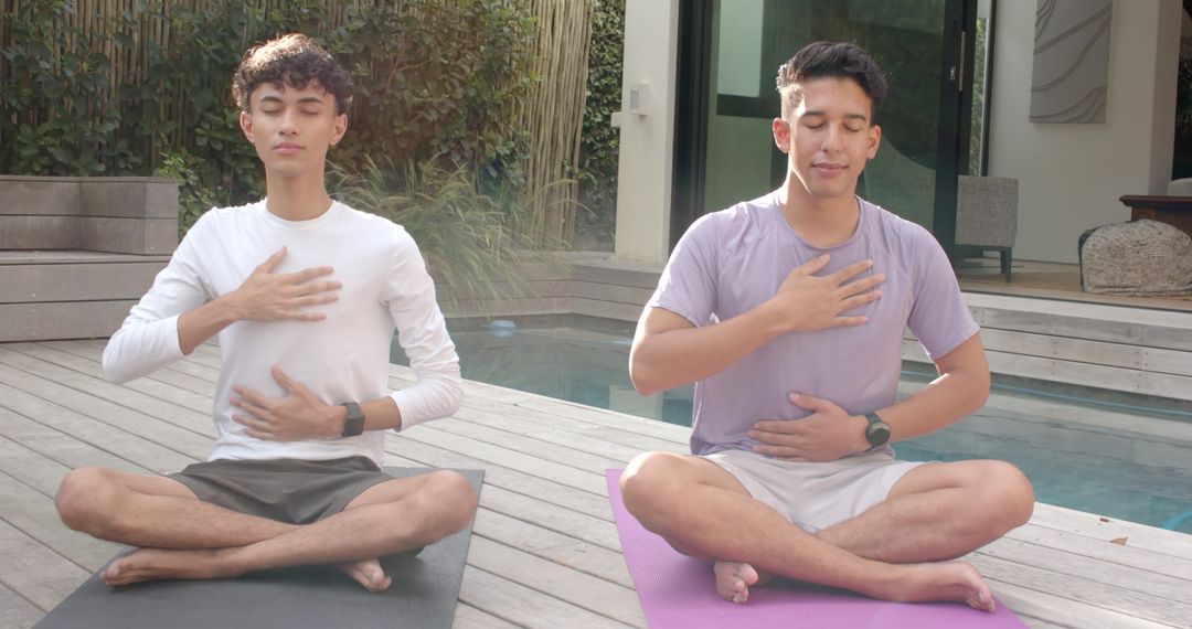Diverse Friends Meditating by Pool in Serene Outdoor Setting