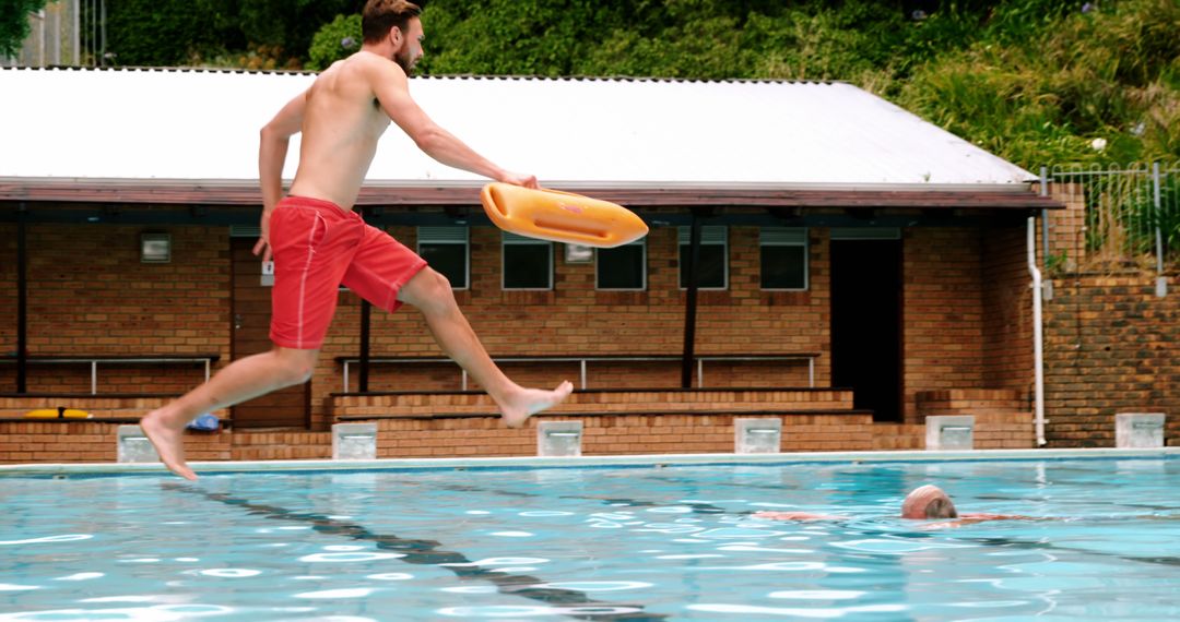 Lifeguard Jumping Into Pool to Rescue Swimmer - Free Images, Stock Photos and Pictures on Pikwizard.com