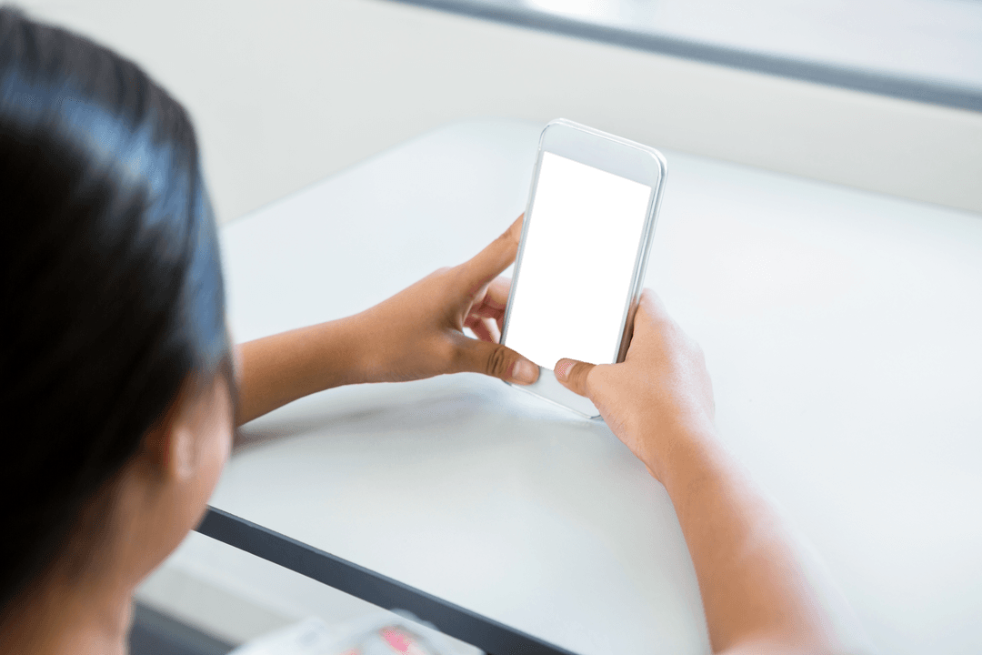 Transparent Mobile Phone in Woman's Hands at Table