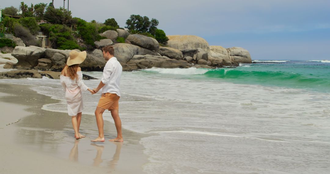Romantic Couple Walking on Sandy Beach Near Ocean Waves
