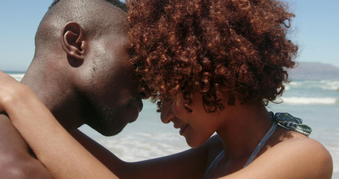 Young African American Couple Embracing on Sunny Beach - Free Images, Stock Photos and Pictures on Pikwizard.com