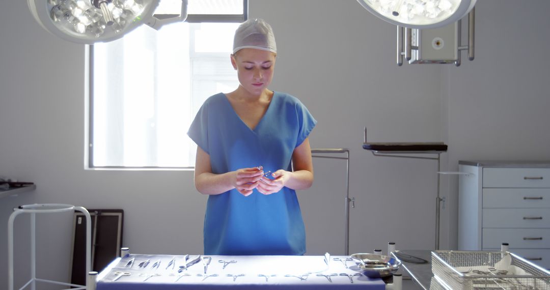 Female Surgeon Preparing Surgical Instruments in Operating Room - Free Images, Stock Photos and Pictures on Pikwizard.com