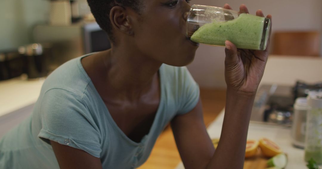 Woman Drinking Fresh Green Smoothie in Modern Kitchen - Free Images, Stock Photos and Pictures on Pikwizard.com