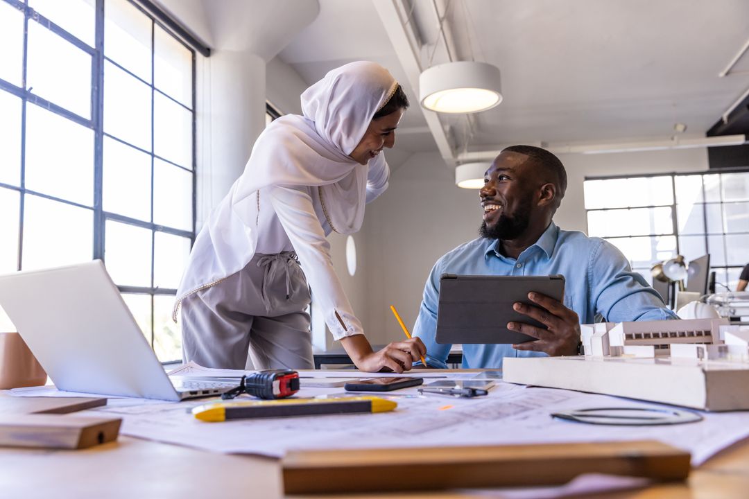 Diverse Coworkers Collaborating on Architectural Project in Modern Office