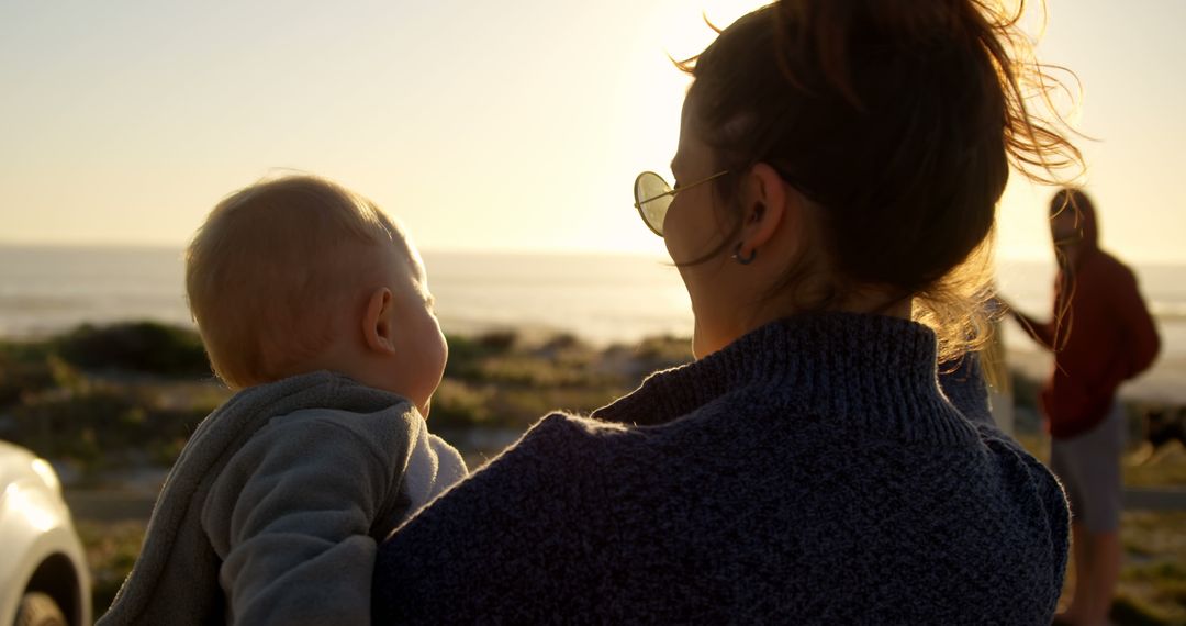 Mother Holding Son on Beach at Sunset - Free Images, Stock Photos and Pictures on Pikwizard.com