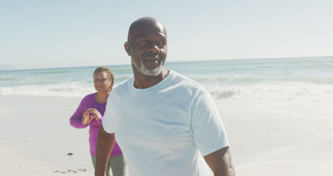 Senior Couple Enjoying a Walk on the Beach - Free Images, Stock Photos and Pictures on Pikwizard.com