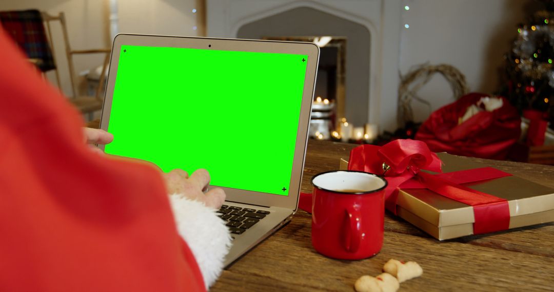 Person in Santa Suit Using Laptop with Green Screen in Festive Home - Free Images, Stock Photos and Pictures on Pikwizard.com