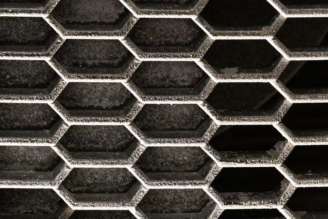 Hexagonal Metal Grille Honeycomb Pattern Showing Dust, Rust and Industrial Texture