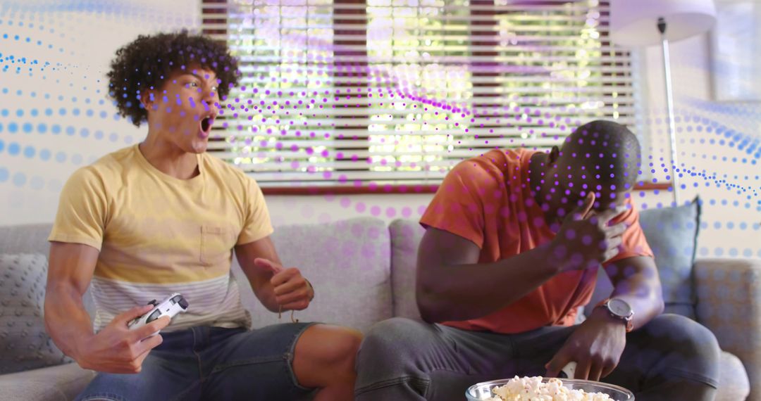 Friends Reacting and Celebrating While Playing Console Games on Sunlit Couch