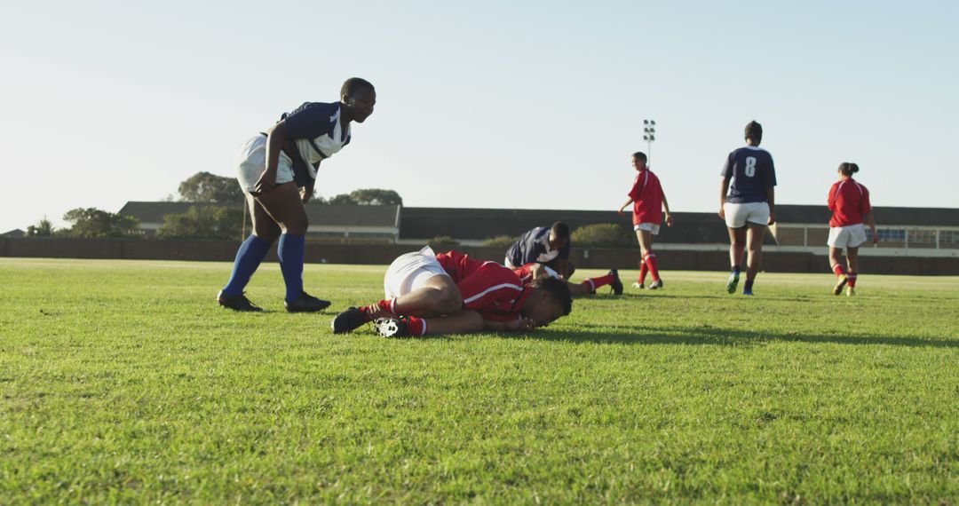 Rugby Players in Action on Green Field with Teammates in Background - Free Images, Stock Photos and Pictures on Pikwizard.com