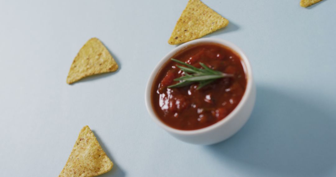 Image of tortilla chips and salsa dip on a grey surface - Free Images, Stock Photos and Pictures on Pikwizard.com