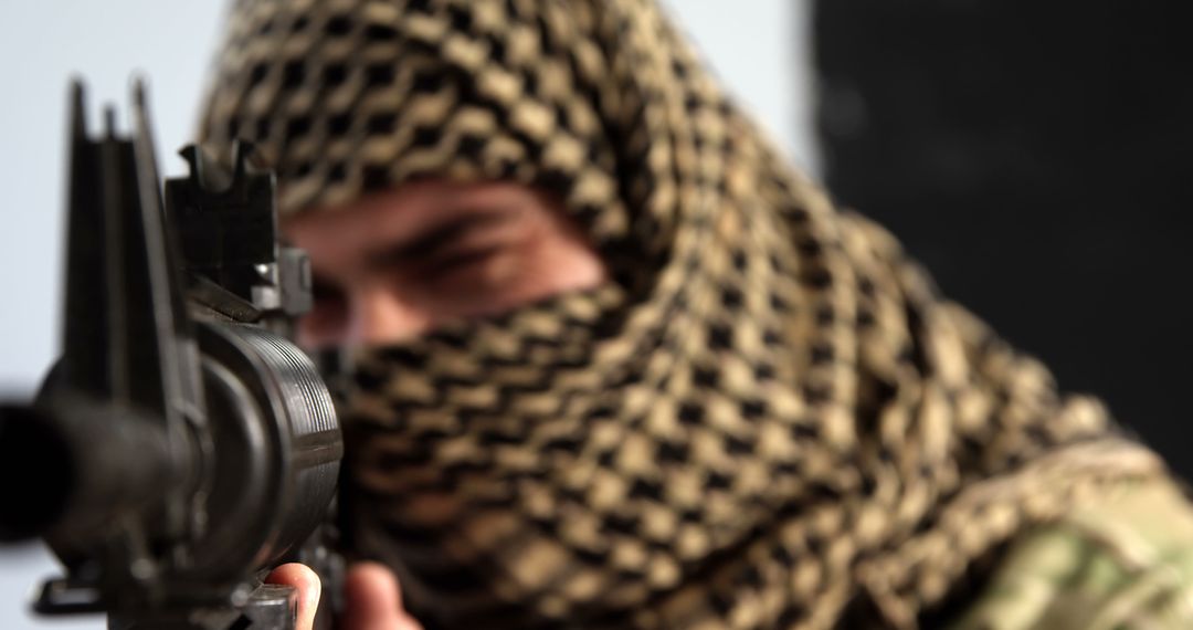 Man Aiming Rifle in Tactical Keffiyeh Wrap Focused on Target