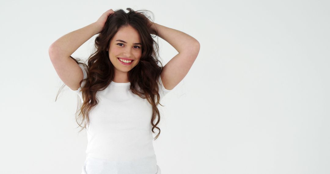 Cheerful Young Woman with Long Hair Smiling in Casual White Shirt - Free Images, Stock Photos and Pictures on Pikwizard.com