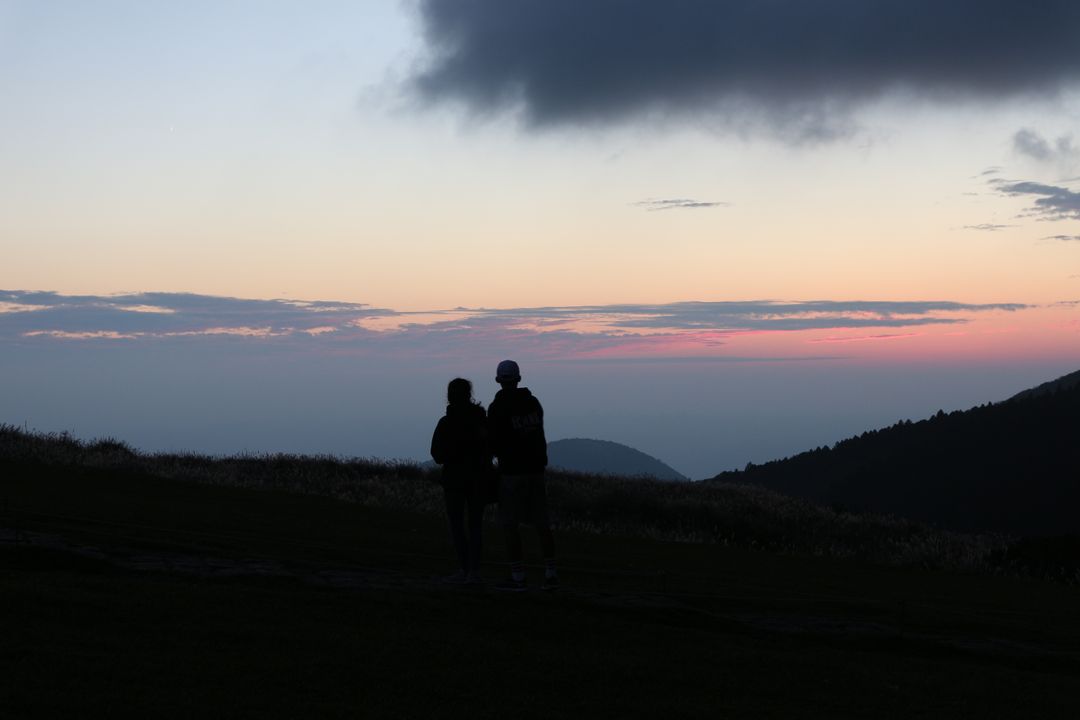 Silhouetted Couple Hiking at Dusk with Scenic Sunset Background - Free Images, Stock Photos and Pictures on Pikwizard.com