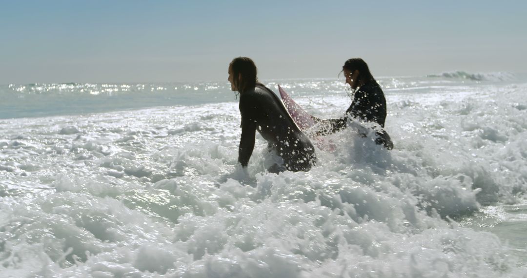 Surfers Entering Ocean Waves on Sunny Day - Free Images, Stock Photos and Pictures on Pikwizard.com