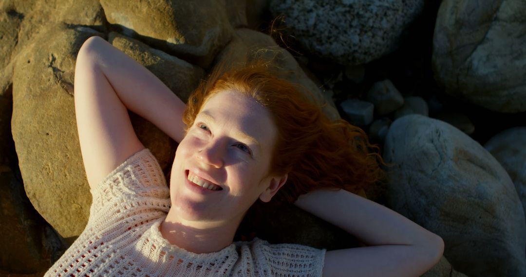 Happy Redhead Woman Smiling Outdoors among Rocks - Free Images, Stock Photos and Pictures on Pikwizard.com