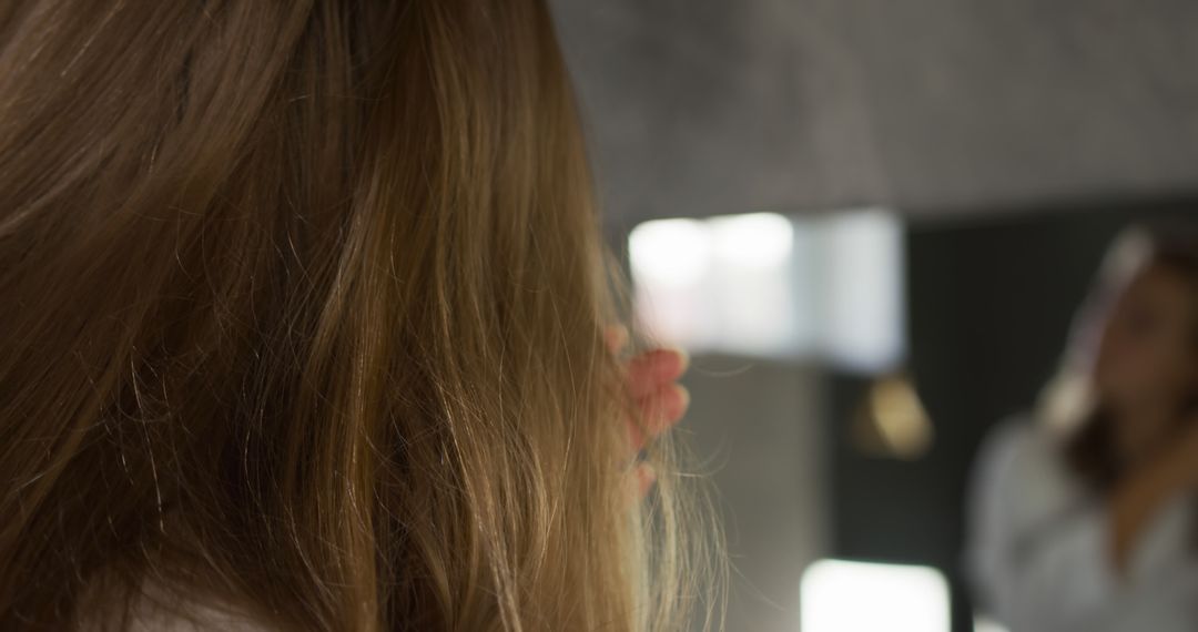 Woman with Long Brown Hair Looking in Mirror - Free Images, Stock Photos and Pictures on Pikwizard.com