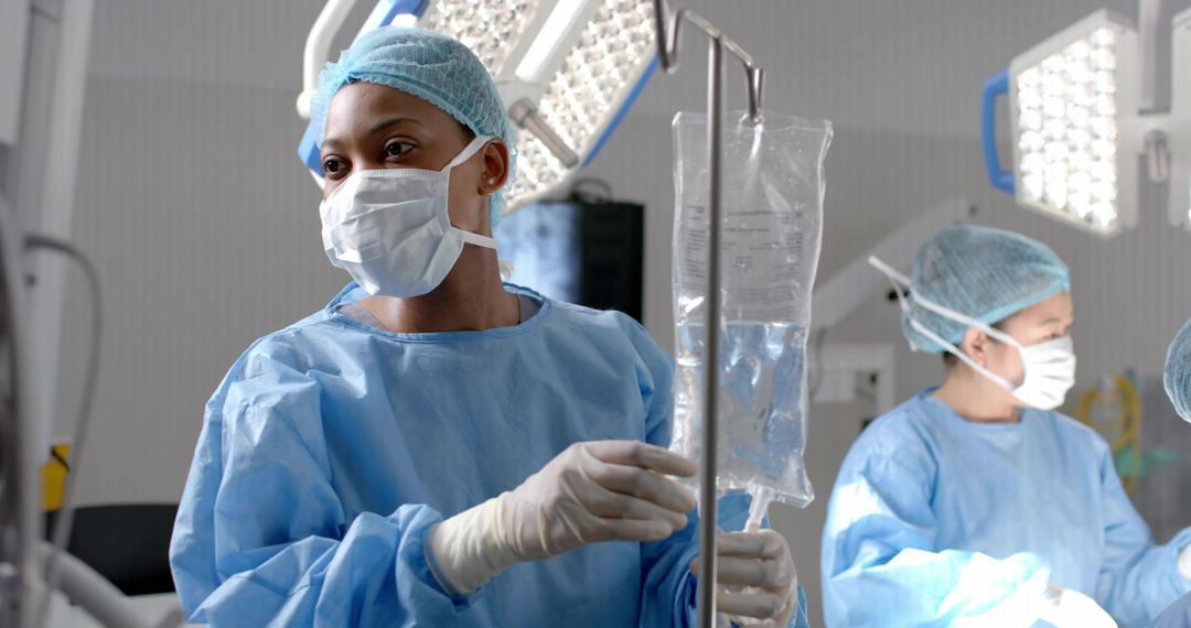 Surgeon Adjusting IV Drip during Surgery in Operating Theater