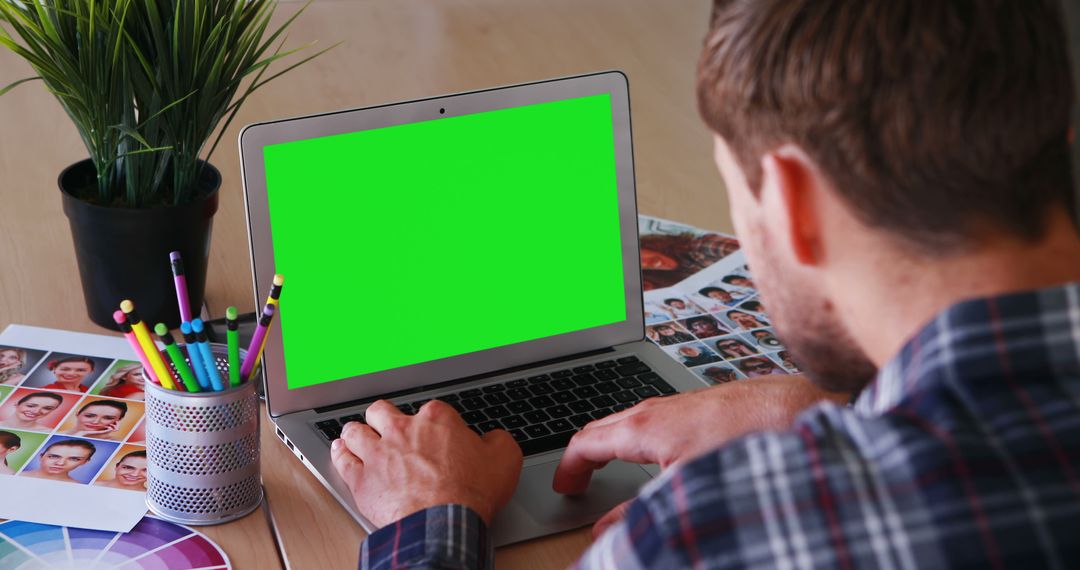 Graphic Designer Editing Images on Laptop with Green Screen - Free Images, Stock Photos and Pictures on Pikwizard.com