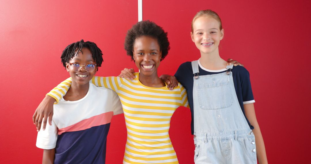 Cheerful Diverse Kids Smiling Together In Front of Red Background
