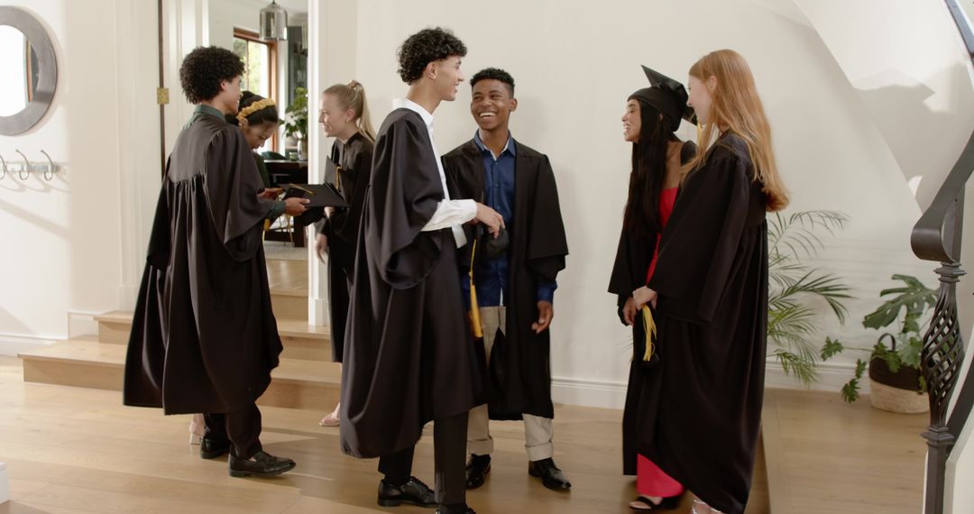 Diverse Graduates Celebrating and Exchanging Diploma Covers in Elegant Foyer