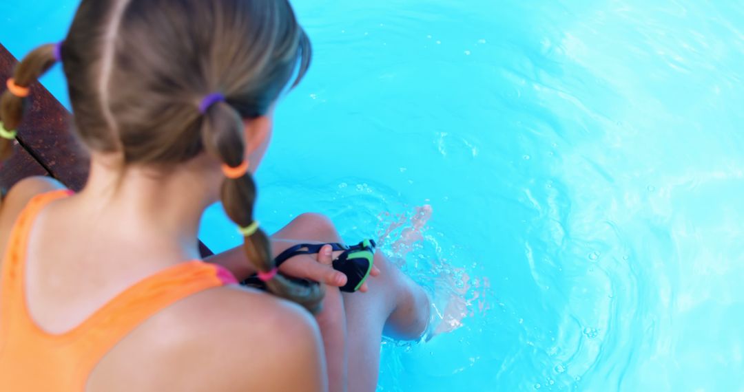 Girl Sitting by Pool's Edge Dipping Her Feet in Water - Free Images, Stock Photos and Pictures on Pikwizard.com