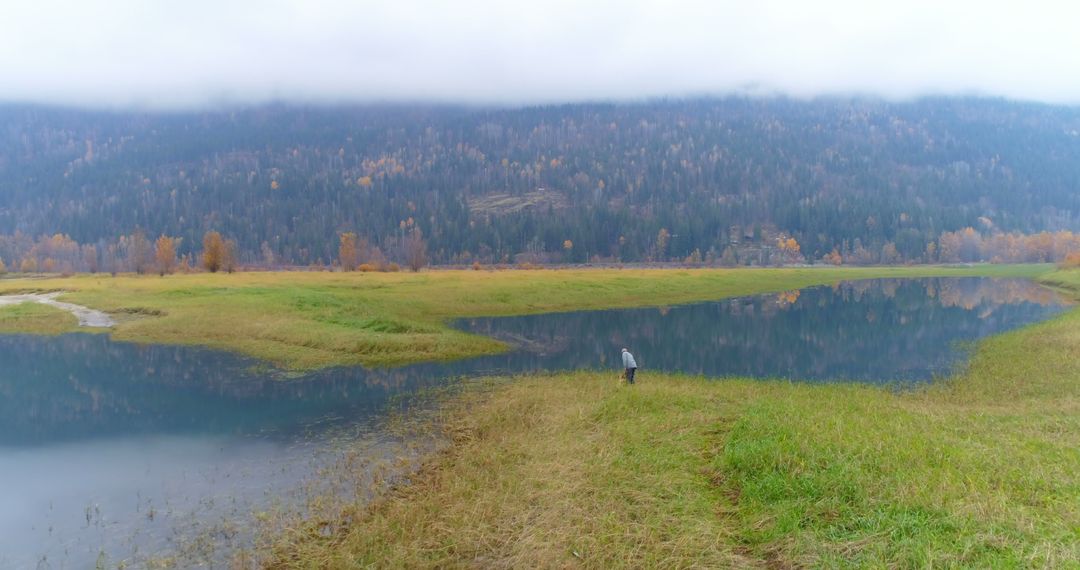 Serene Lake with Fog Over Forested Mountains at Sunrise - Free Images, Stock Photos and Pictures on Pikwizard.com