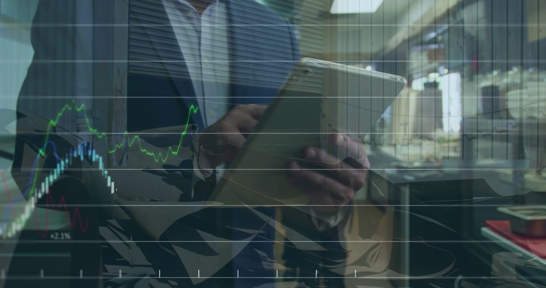 Businessman Analyzing Financial Data on Tablet with Overlayed Graphs