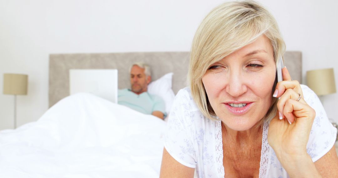 Mature Couple Multitasking with Technology in Comfort of Home