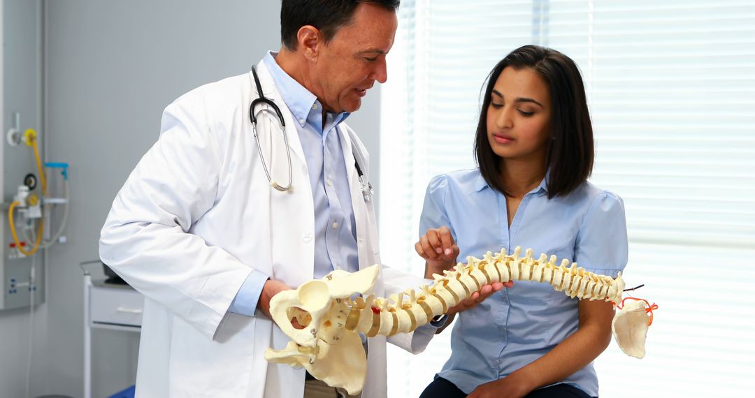 Doctor Explaining Spinal Anatomy to Female Patient - Free Images, Stock Photos and Pictures on Pikwizard.com