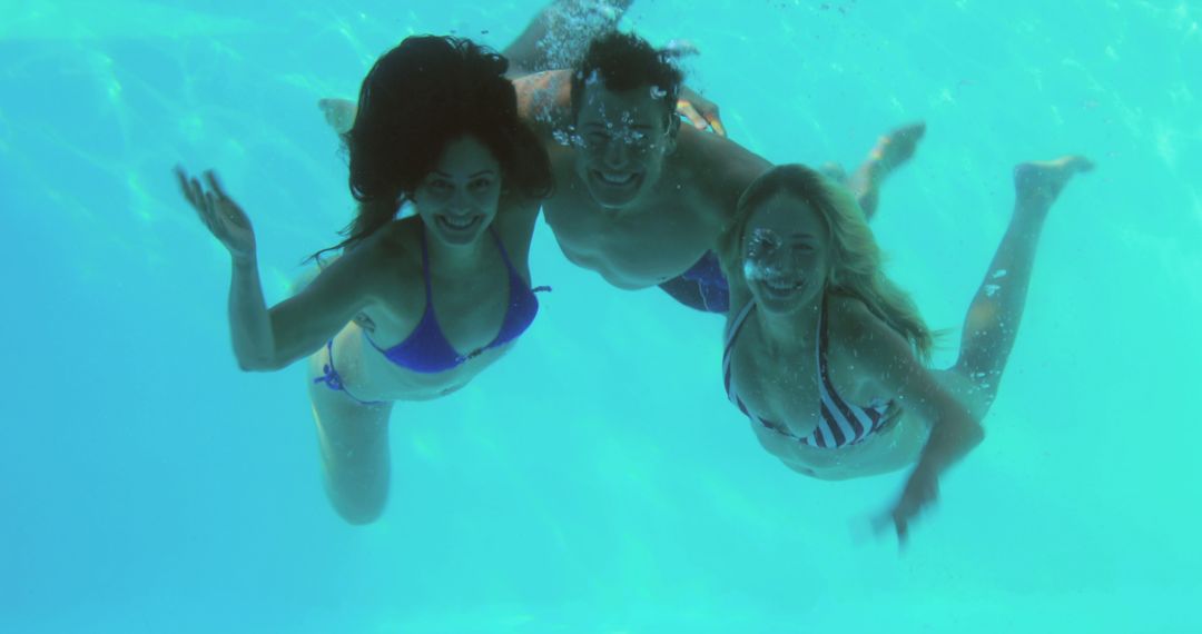 Group of Friends Enjoying Underwater Swimming in Pool - Free Images, Stock Photos and Pictures on Pikwizard.com