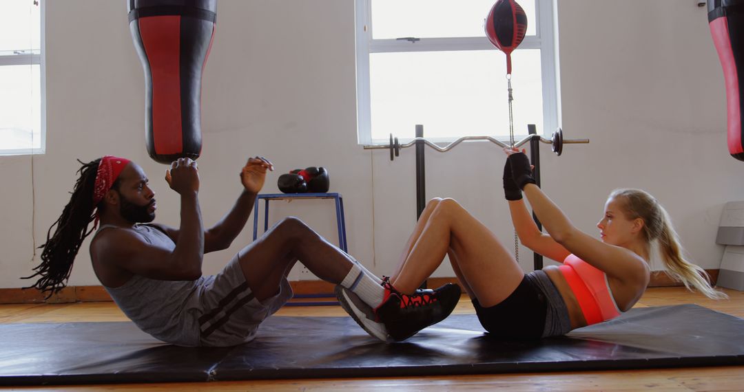 Diverse Athletic Couple Training Together with Punching Bag - Free Images, Stock Photos and Pictures on Pikwizard.com