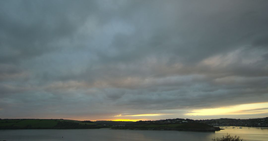 Dramatic Cloudy Sky Over Serene Lake at Sunset - Free Images, Stock Photos and Pictures on Pikwizard.com