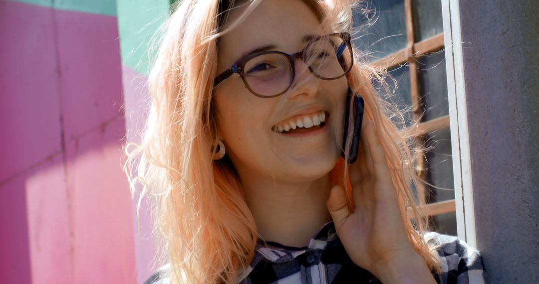 Happy Young Woman Talking on Smartphone Outdoors - Free Images, Stock Photos and Pictures on Pikwizard.com