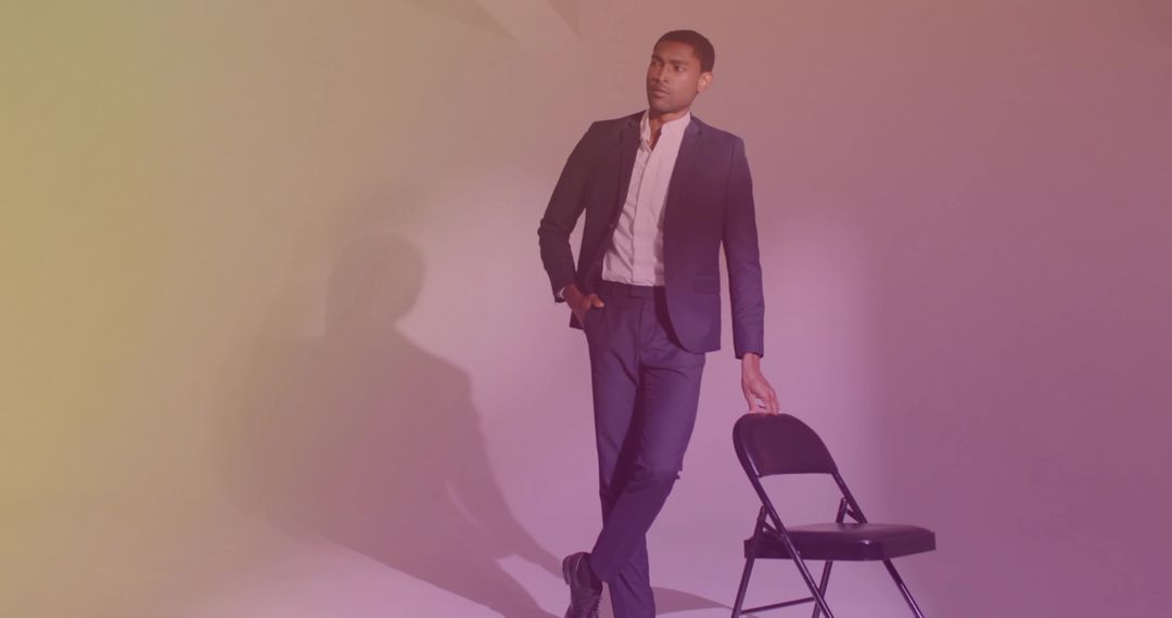 Casually Elegant Man in Tailored Suit Leaning on Chair