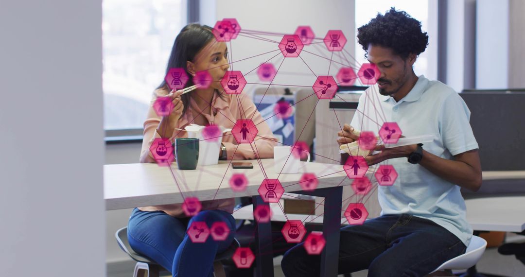 Office colleagues sharing lunch with hexagon network overlay illustrating digital collaboration