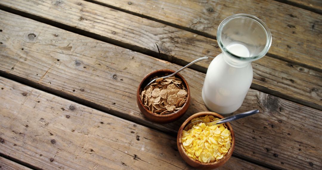 Healthy Breakfast with Milk, Cornflakes and Bran Flakes on Rustic Wooden Table - Free Images, Stock Photos and Pictures on Pikwizard.com