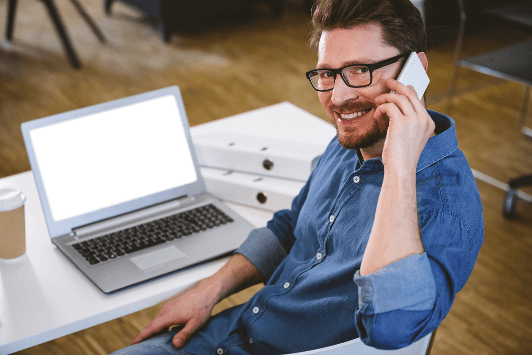 Transparent-screen laptop with cheerful man using mobile phone office